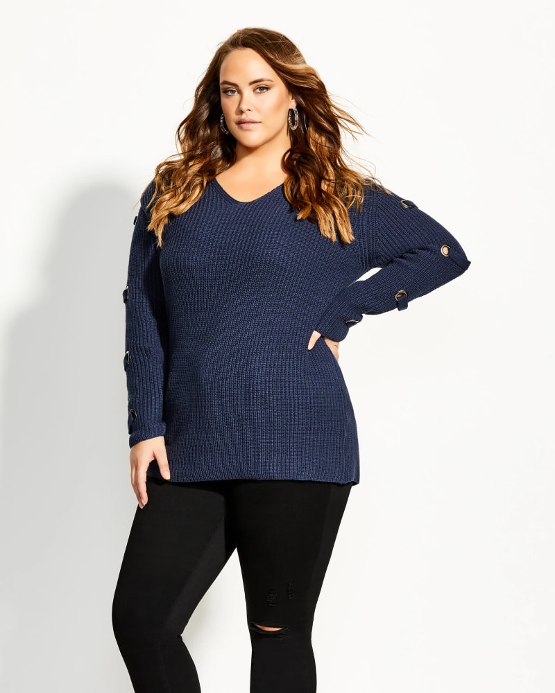 Front of a model wearing a size 22W City Chic Women's Trendy Plus Size Grommet-Sleeved Sweater Dark Blue Size 22W in Blue by City Chic. | dia_product_style_image_id:314333